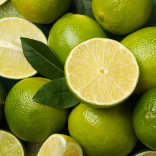 Fresh ripe lime with leaves on whole background